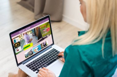 Dizüstü bilgisayar kullanan genç bir kadın. Çevrimiçi alışveriş kavramı