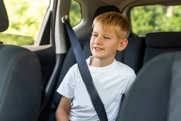 Young little boy buckled up with seatbelt inside the car — Stock Photo, Image