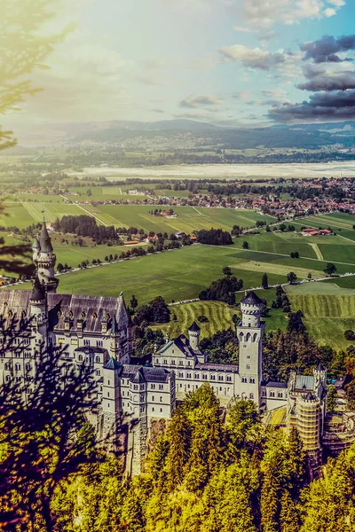 美丽的新天鹅堡在金秋时节的鸟瞰图。位于德国巴伐利亚州的宫殿。新天鹅城堡的最受欢迎的行宫之一和旅行的目的地在欧洲和世界. — 图库照片