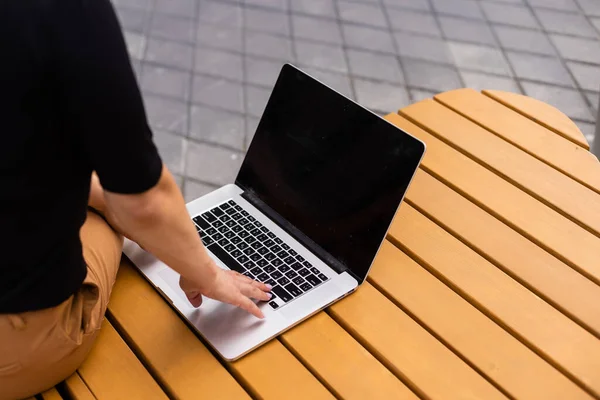 Young woman with laptop outside