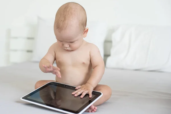 Bebek beyazı izole edilmiş dijital tabletle oynuyor — Stok fotoğraf