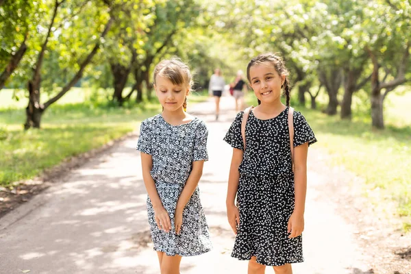 Porträtt av två flickor med skolväskor efter lektionen i skolan — Stockfoto