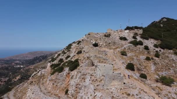 Mills in motion on mountain peak by Mediterranean sea, Crete, Greece — Stock Video