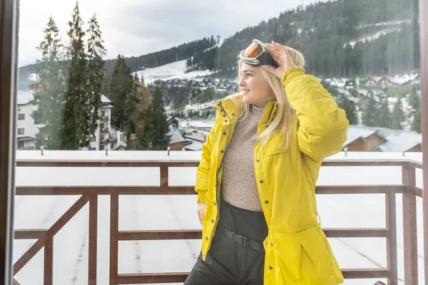 Woman on a terrace admiring in the snowy mountains — Stock Photo, Image