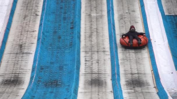 Kiev Ukraine - January 11, 2021: mountain for descent on an inflatable ring on the territory of the National Complex Expocenter of Ukraine VDNH — Stock Video