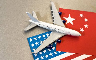 Flag of China with passport and toy airplane on wooden background. Flight travel concept. High quality photo