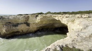 Portekiz 'deki Algarve sahili, çatısı büyük dairesel bir açıklığı olan çarpıcı bir doğal deniz mağarası. Yüksek kalite fotoğraf