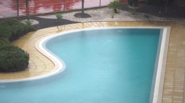 Güverte sandalyeli yüzme havuzunun yanındaki dinlenme odasının penceresinden bak. Muhteşem arka bahçenin iç tasarımı ve dinlenmek için geniş bir avlu. Yüksek kalite 4k görüntü