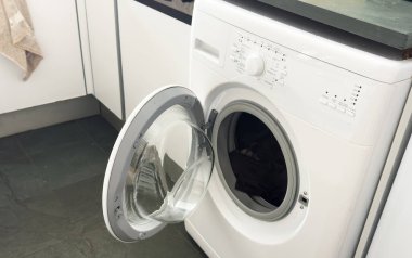 Beyaz ve ahşap arka planda açık kapı çamaşır makinesi. Yüksek kalite fotoğraf