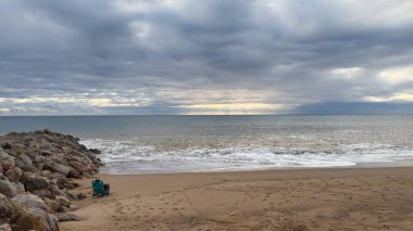 Atlantik 'te kumlu bir sahil. Kum taşı kayalıkları olan bir sahilin gün batımında manzara. Albufeira, Algarve, Portekiz yakınlarındaki Praia 'nın sarı sahilinde gelgit var. Yüksek kalite fotoğraf