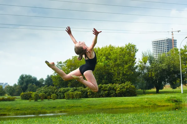 Ung vacker preteen flicka gör gymnastik utomhus — Stockfoto