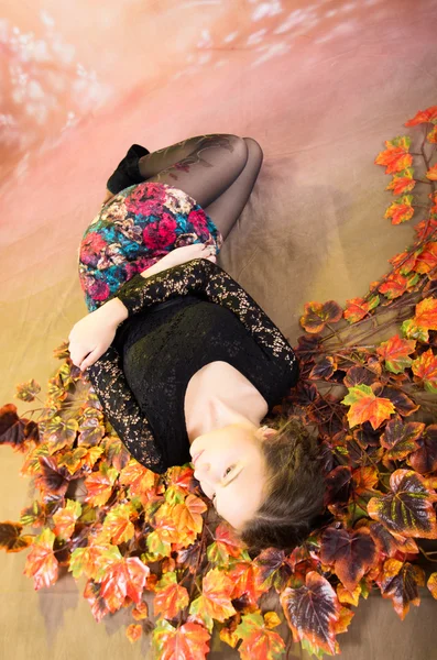 Young pretty teenage girl with autumn leaves — Stock Photo, Image