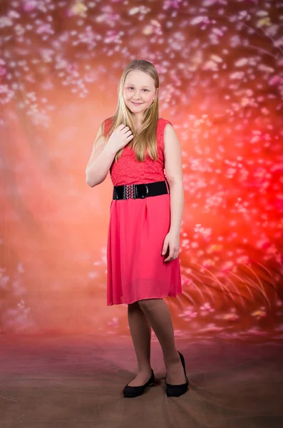 Young girl in red dress pose in studio — Stock Photo, Image