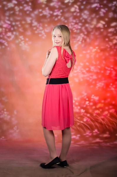 Young girl in red dress pose in studio — Stock Photo, Image