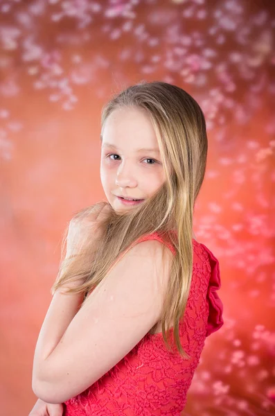 Young girl in red dress pose in studio — Stock Photo, Image