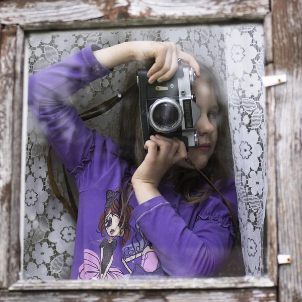 Cheerful kid holding old camera retro — Stock Photo, Image