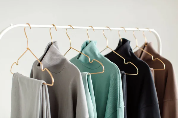 Stylish and comfortable clothes for teenagers hang on a hanger. Clothes for convenience on a white background