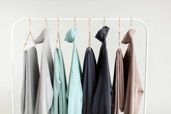 Stylish and comfortable clothes for teenagers hang on a hanger. Clothes for convenience on a white background