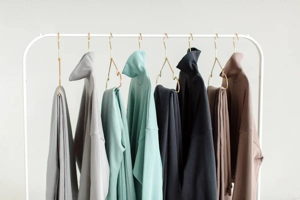 Stylish and comfortable clothes for teenagers hang on a hanger. Clothes for convenience on a white background