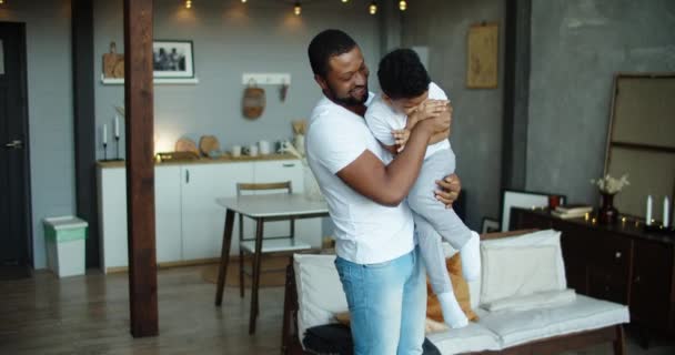 Feliz africano americano padre cosquillas riendo adorable hijo de cerca, familia divirtiéndose en casa, sonriente papá abrazando a niño pequeño, jugando juego, disfrutando de fin de semana — Vídeos de Stock