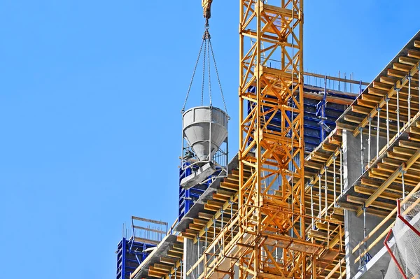 Crane lifting cement mixing container — Stock Photo, Image