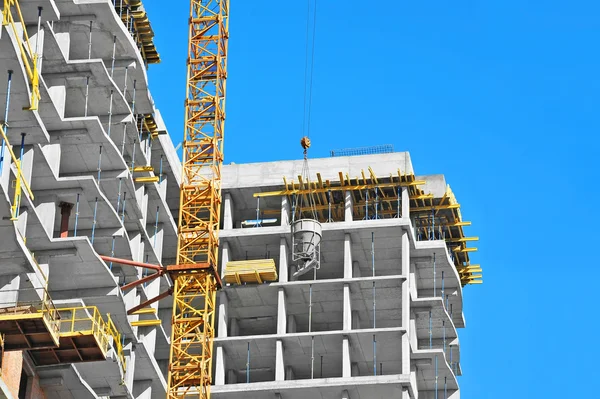 Crane lifting cement mixing container — Stock Photo, Image