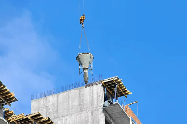 Crane lifting cement mixing container — Stock Photo, Image