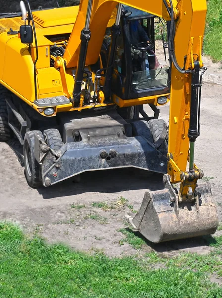 Work of excavating machine on building construction site