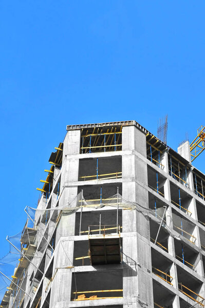 High-rise building construction site work with scaffolding