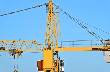 Mavi gökyüzüne karşı yüksek inşaat kulesi vinci