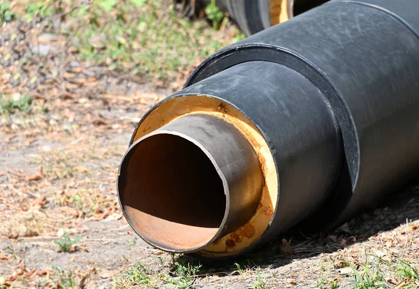 Rusty steel pipe with heat insulation on construction site