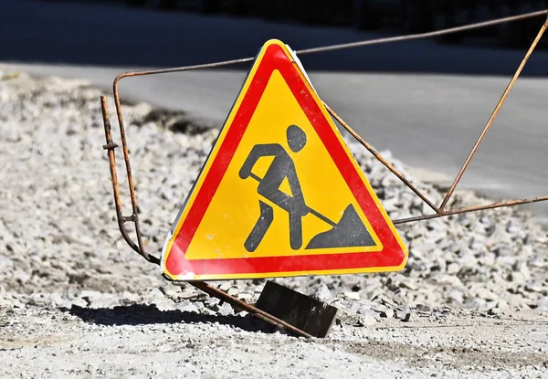 Warning sign on road construction site work