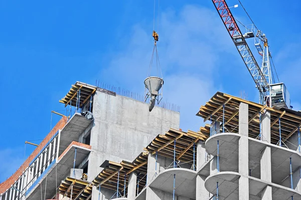 Crane lifting cement mixing container — Stock Photo, Image