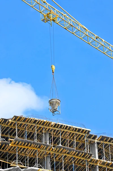 Crane lifting cement mixing container — Stock Photo, Image