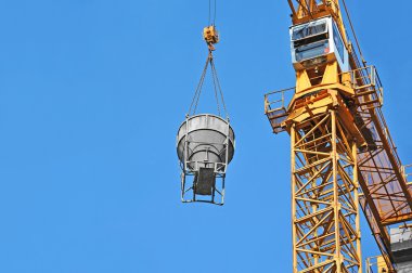 Crane lifting cement mixing container clipart