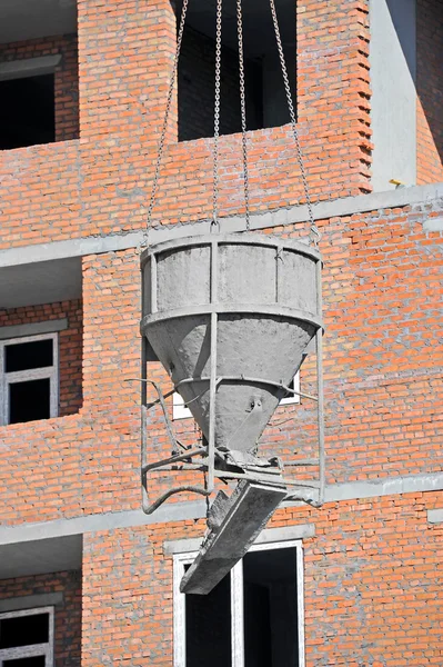 Crane lifting cement mixing container — Stock Photo, Image