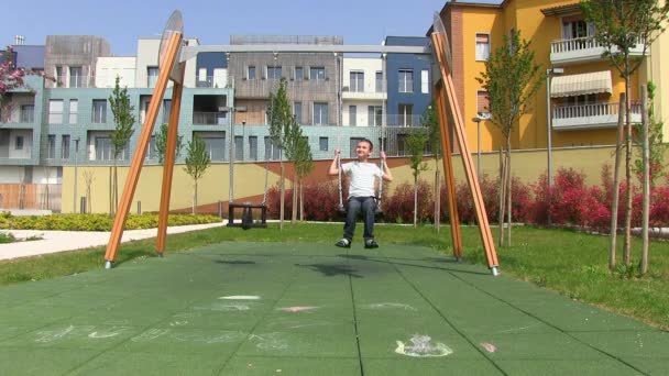 Boy riding on a swing — Stock Video