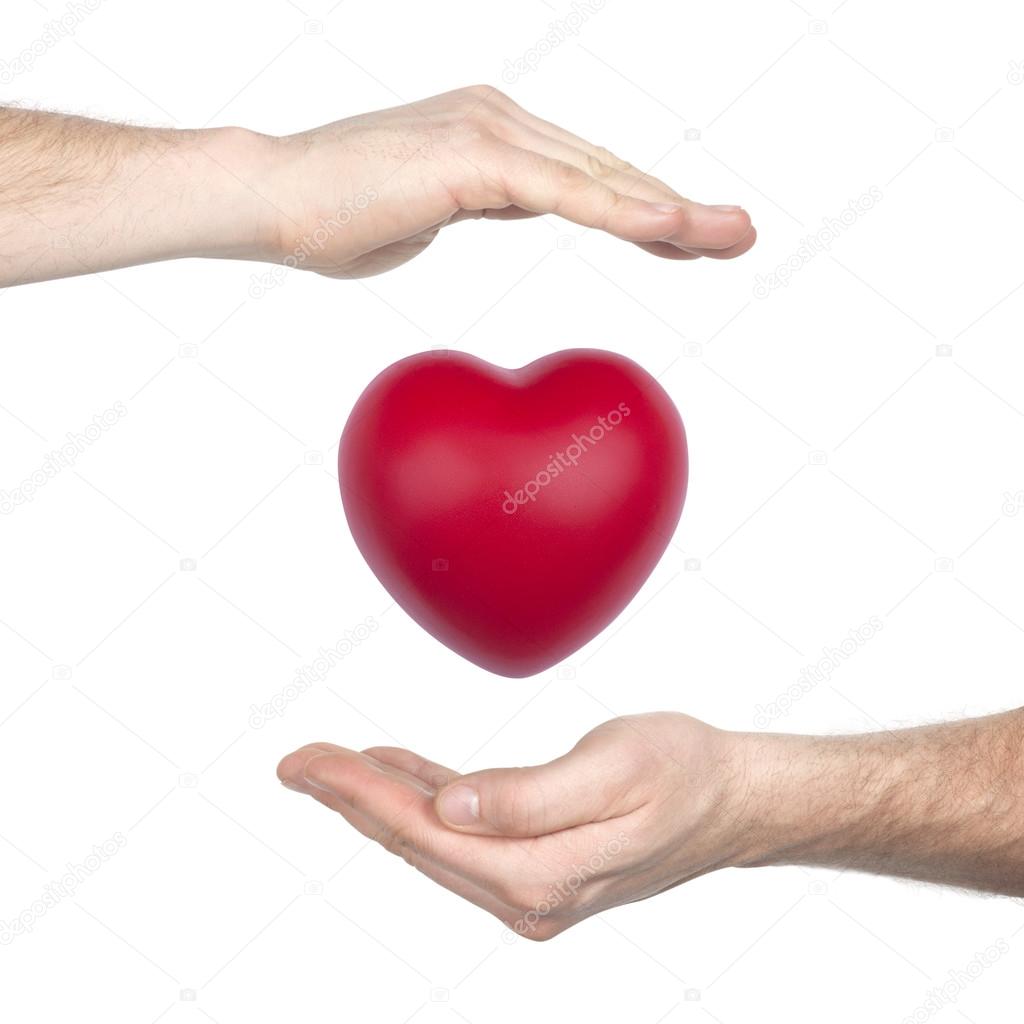 male hands holding red heart