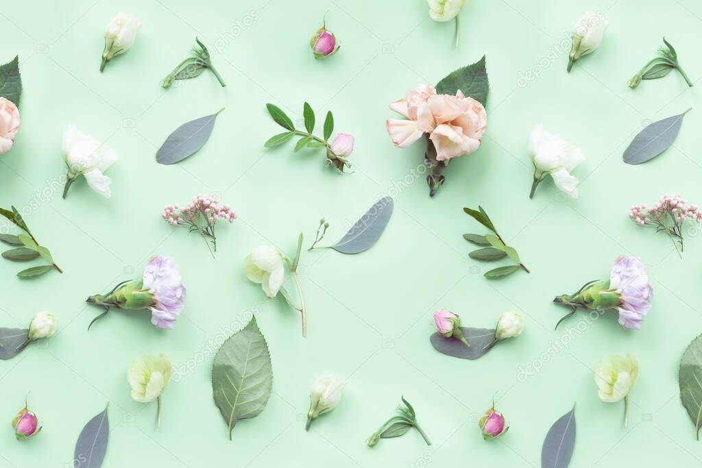 Pattern floral with rosebuds, delicate white flowers, branches, leaves and petals on a green background. Flat layout, top view