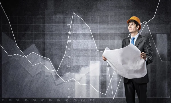 Engineer wearing helmet with papers — Stock Photo, Image