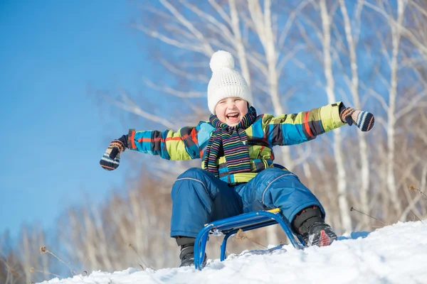 Boy riding on sled — Stock Photo, Image