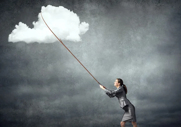 Business woman pulling cloud on lead — стоковое фото