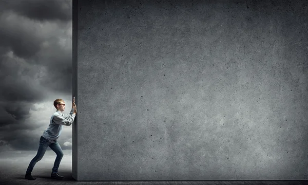 Guy pushing cement banner — Stock Photo, Image