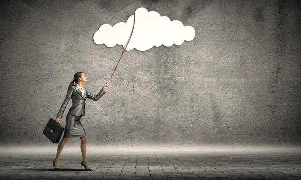 Business woman pulling cloud on lead — стоковое фото