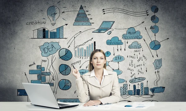 Elegant businesswoman sitting at table — Stock Photo, Image