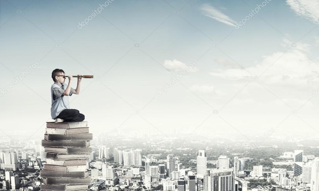 Kid on pile of books looking in spyglass