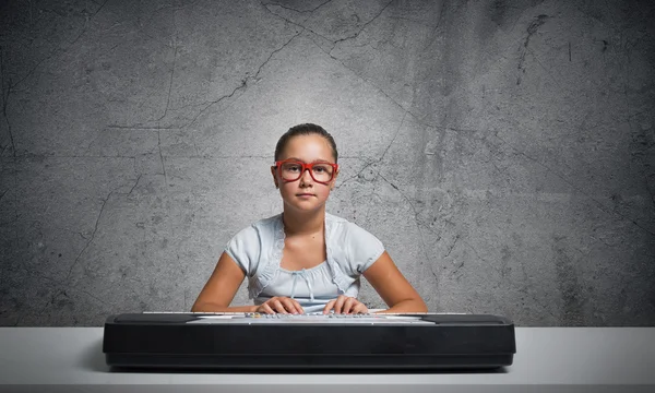 Menina da escola tocando piano — Fotografia de Stock