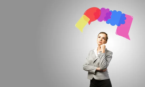 Speech bubbles above businesswoman — Stock Photo, Image