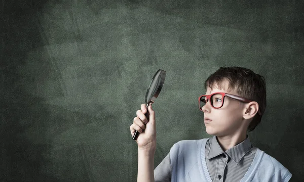 Leuke jongen op zoek via Vergrootglas — Stockfoto