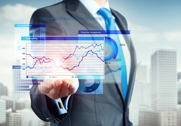 Businessman presenting virtual graphs and charts — Stock Photo, Image